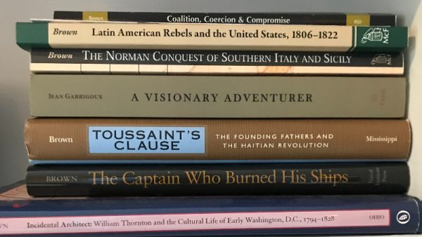 The spines of books written by Gordon Brown in retirement, in his apartment at Ingleside in January 2025